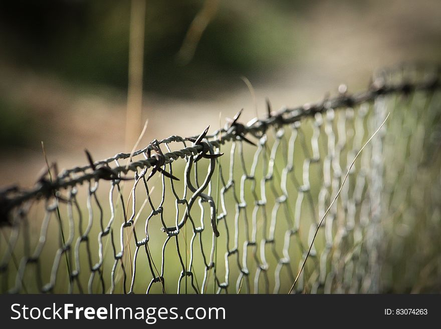 Barbwire on Top of Cyclone Fence