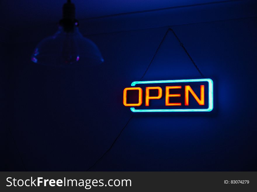 Yellow and Teal Open Neon Signage