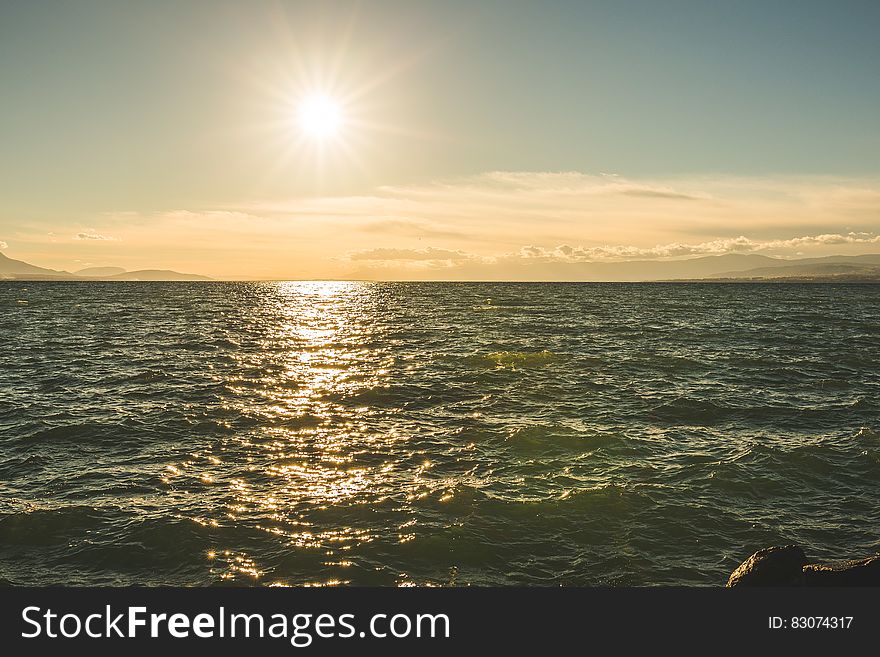 Green Sea Under Blue Sky During Day Time