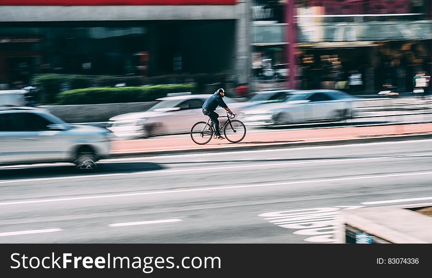 Man in Black Shirt Using Black Road Bicycle