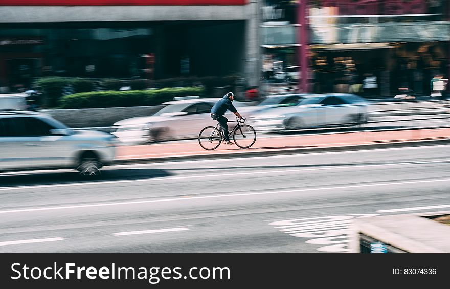 Man In Black Shirt Using Black Road Bicycle