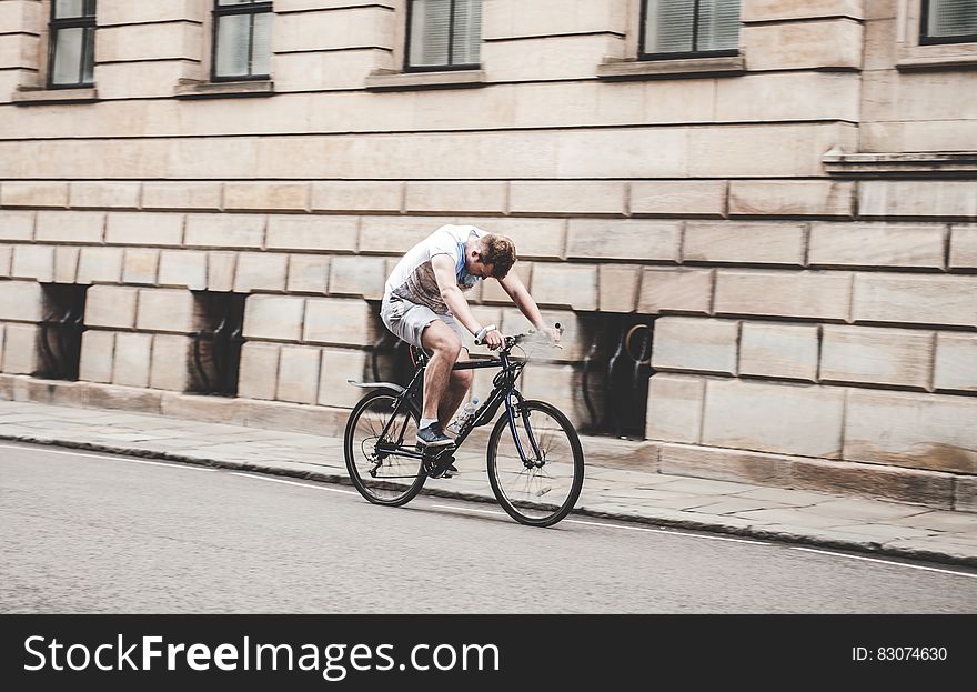 Man Riding Black Mountain Bike on Pathway during Daytime