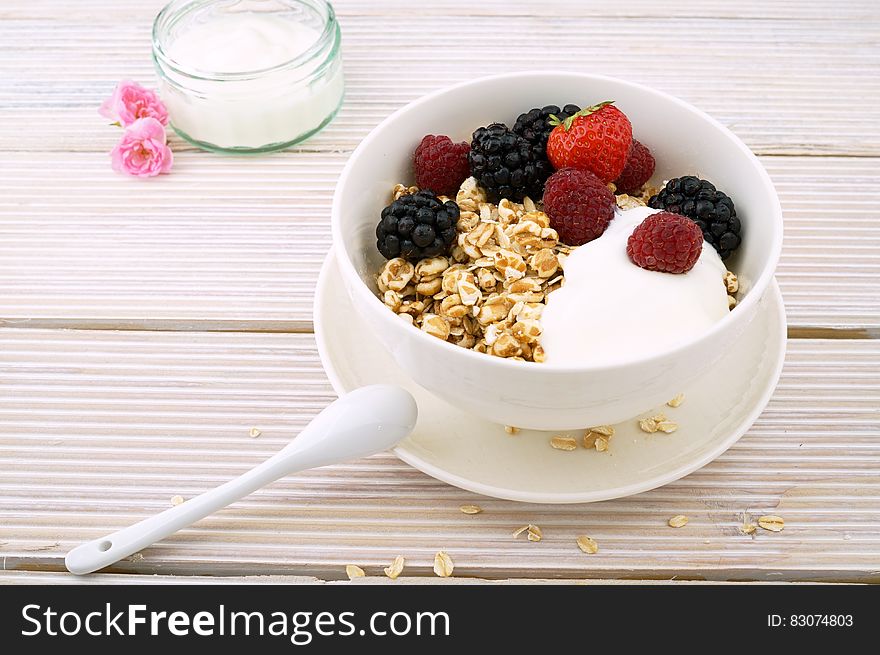 Red Strawberry And Raspberry On White Ceramic Bowl