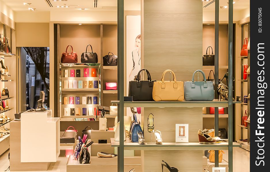 Shelves displaying leather purses and shoes in fashion boutique. Shelves displaying leather purses and shoes in fashion boutique.