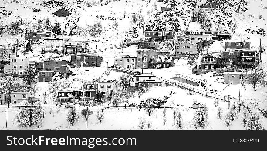 Village On Mountain Covered With Snows