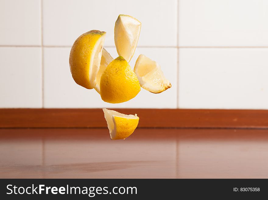 Levitating pieces of lemon over kitchen counter. Levitating pieces of lemon over kitchen counter.