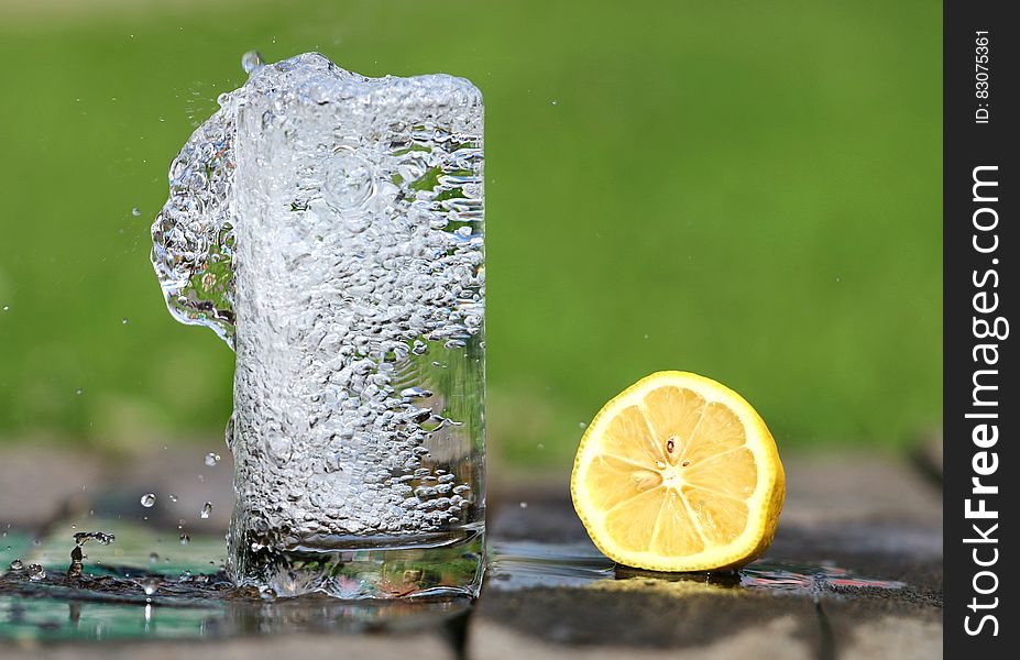 Time Lapse Photography of Water Bobbling Beside Lemon Fruit