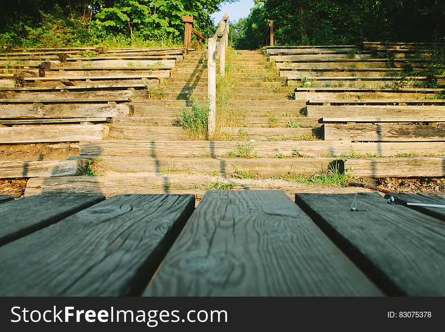 Rows of wooden seats, steps and stage in empty outdoor theater. Rows of wooden seats, steps and stage in empty outdoor theater.