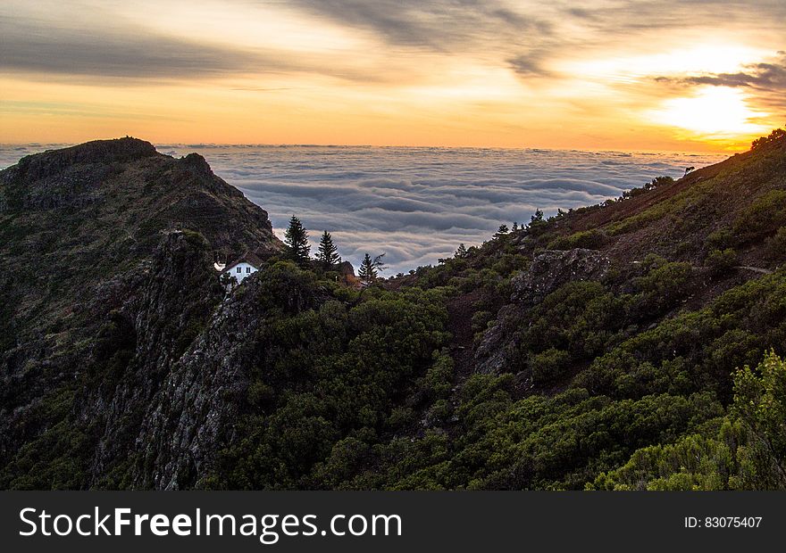 Mountain Above White Clouds during Sunset