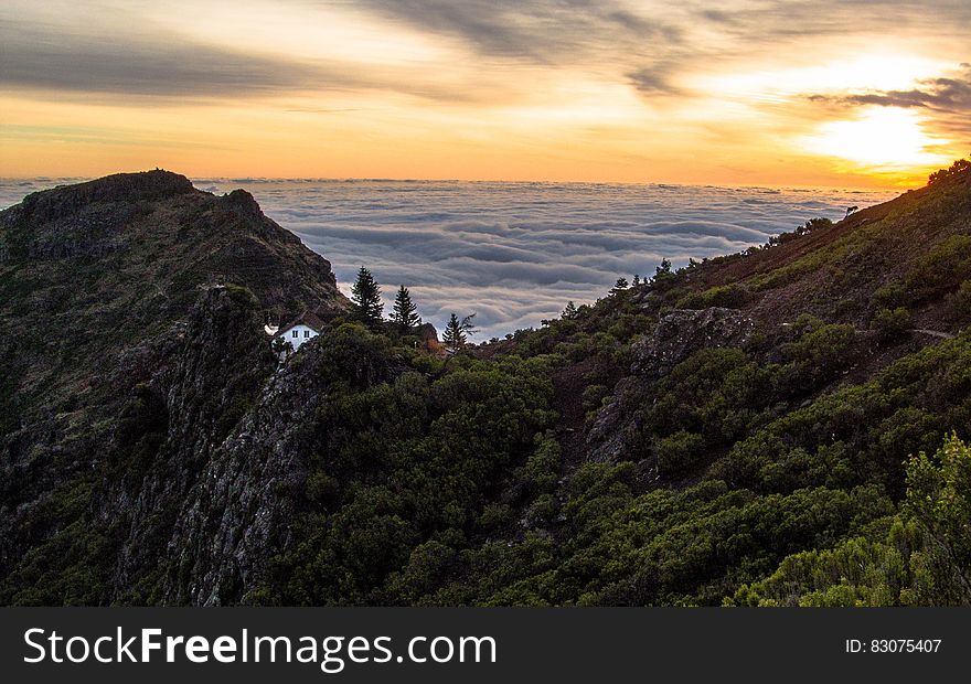 Mountain Above White Clouds During Sunset