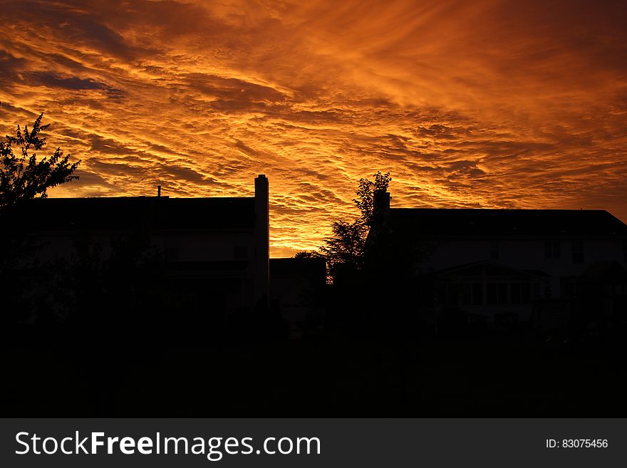 Silhouette Of Buildings Under Orange Sky During Sunset