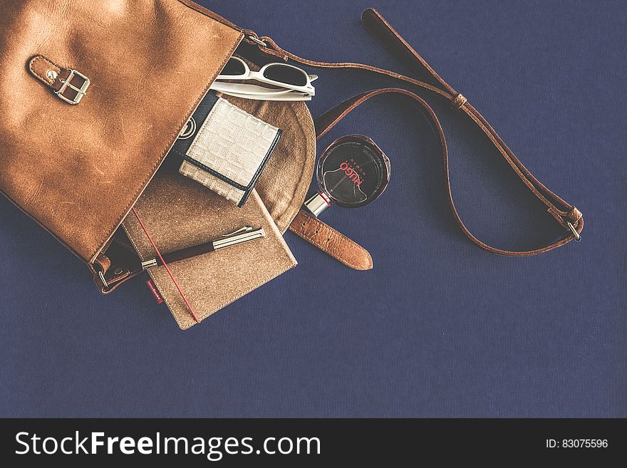 Brown Leather Crossbody Bag With White Framed Sunglasses