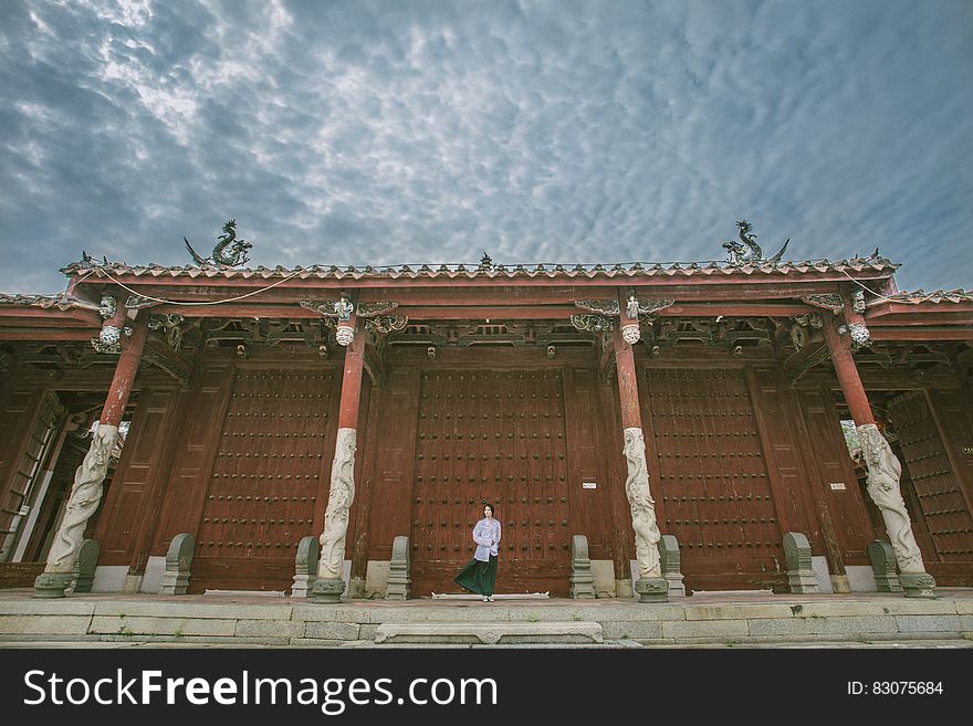 Person Standing Near Red Gate