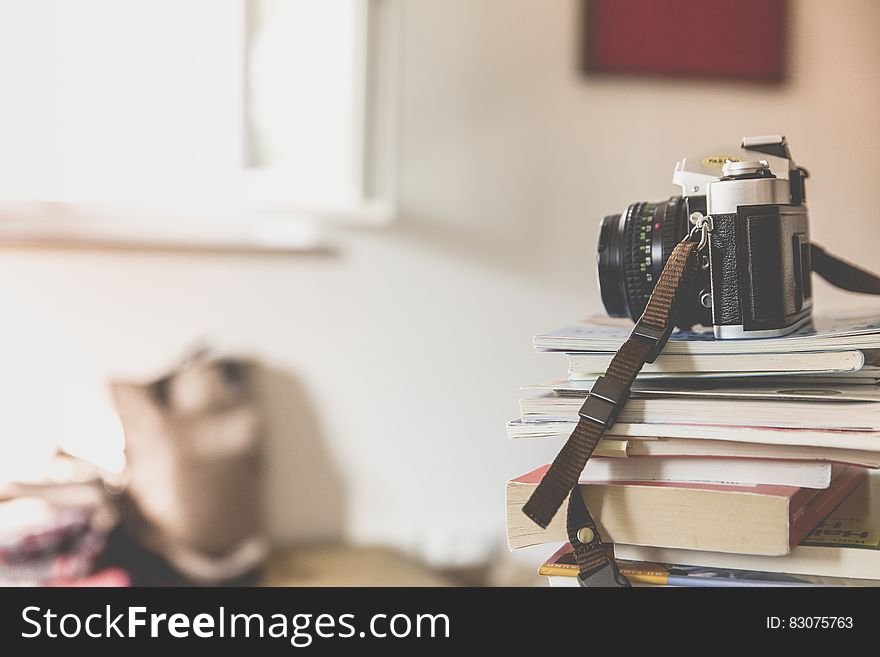 Black Bridge Camera On Top Of Piled Books