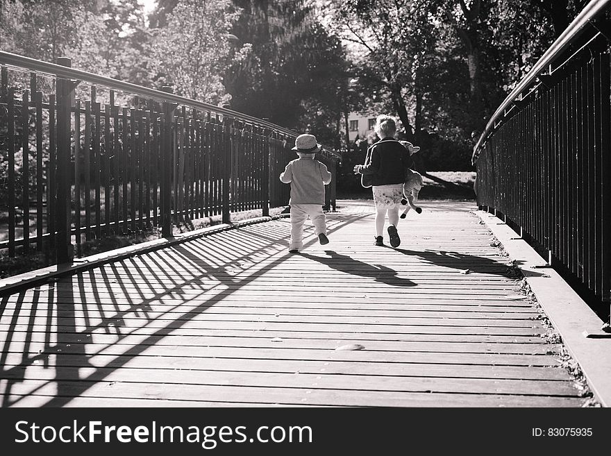 Children Running Together on Wooden Path Way Bridge