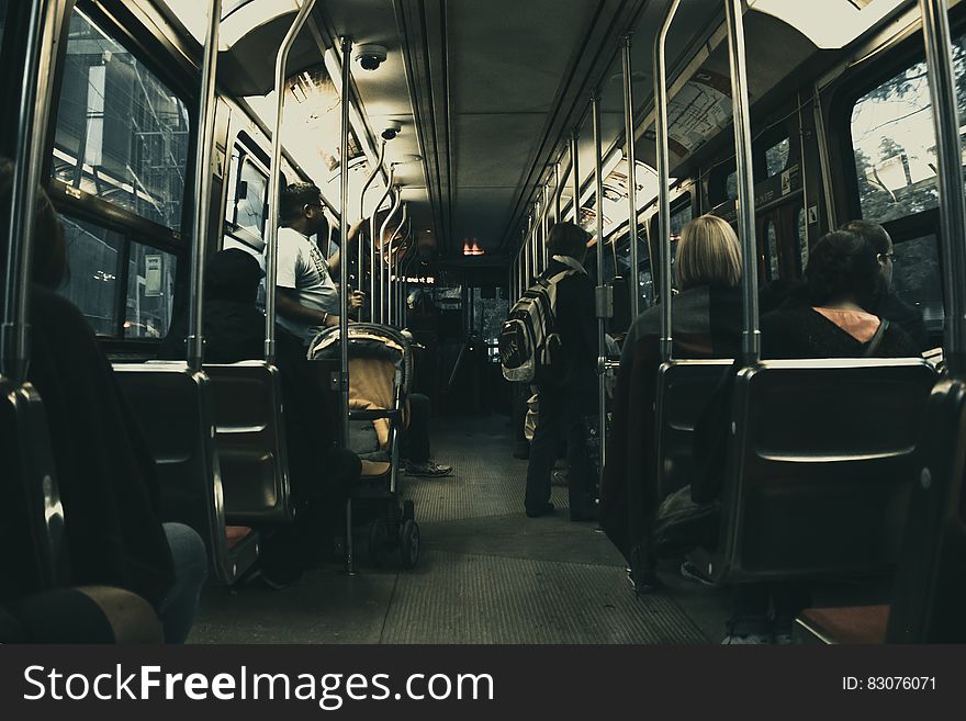 Man in White T Shirt Standing on the Bus