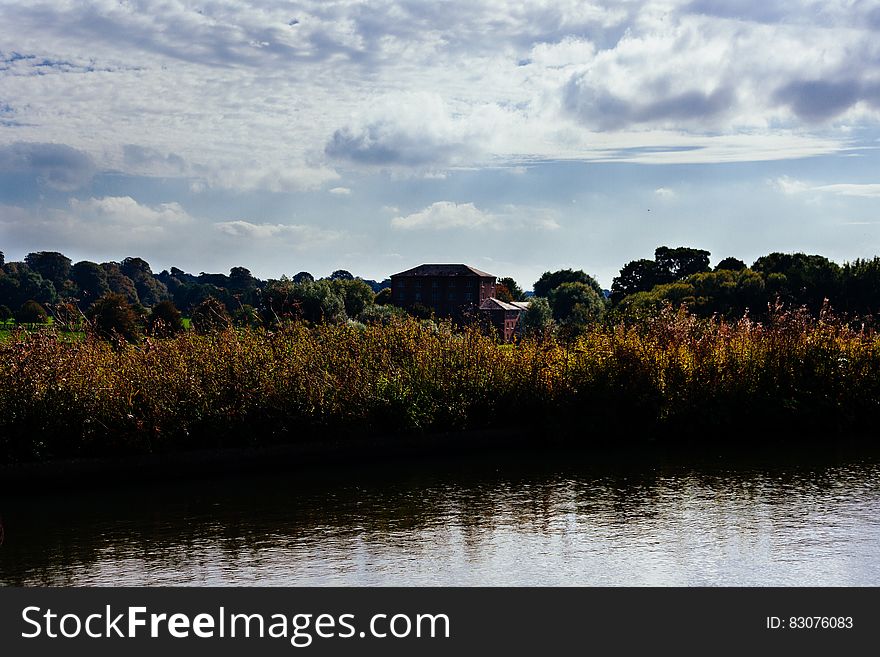 A grassy river bank in a rural region. A grassy river bank in a rural region.