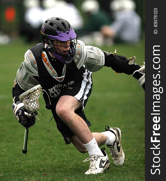 Person In Black Sports Jersey Playing Lacrosse