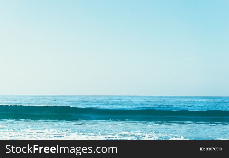 A sea wave and open sea in the background.