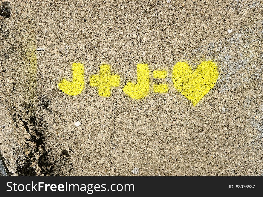 A yellow love equation on a wall. A yellow love equation on a wall.