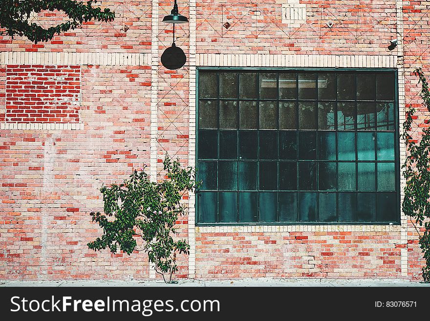 Exterior of industrial building with glass windows and brick wall. Exterior of industrial building with glass windows and brick wall.