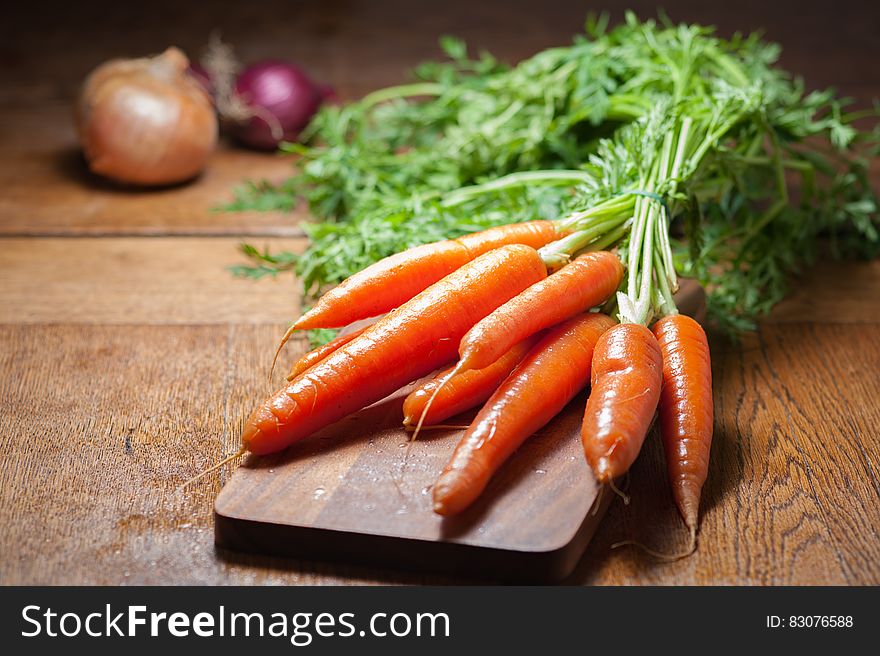 8 Piece Of Carrot On Brown Chopping Board