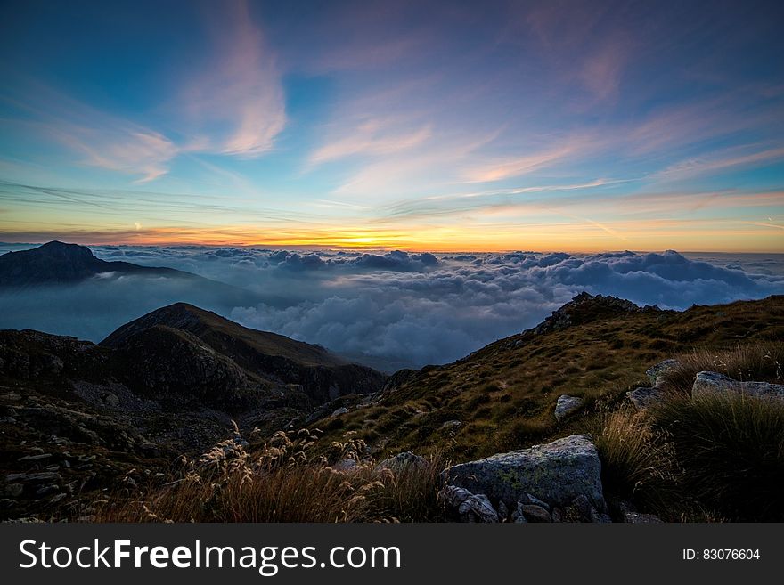 Mountains Above White Clouds Under Blue Sky