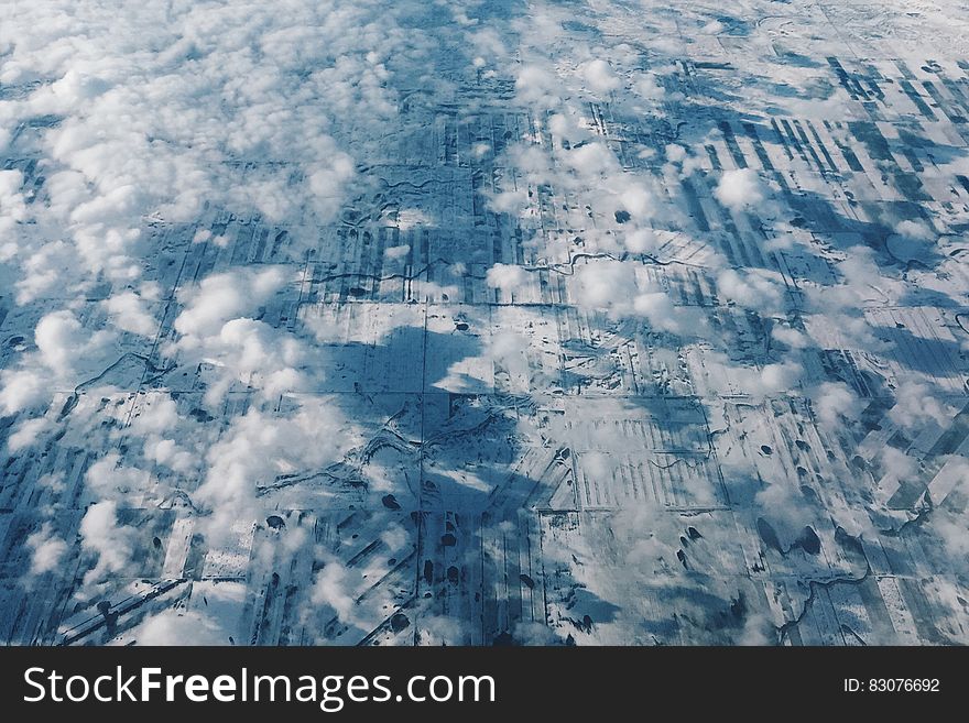 An aerial view of a rural landscape and clouds above. An aerial view of a rural landscape and clouds above.