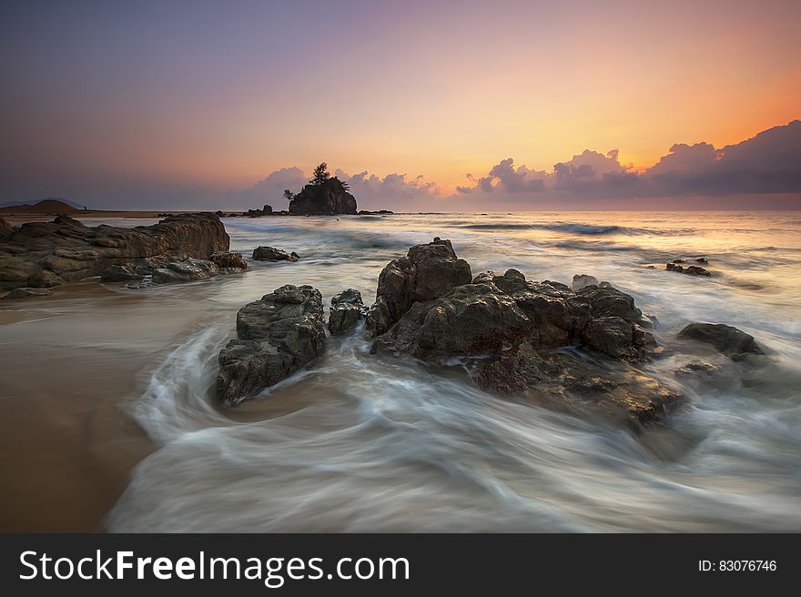 Stone In Seashore During Sunset