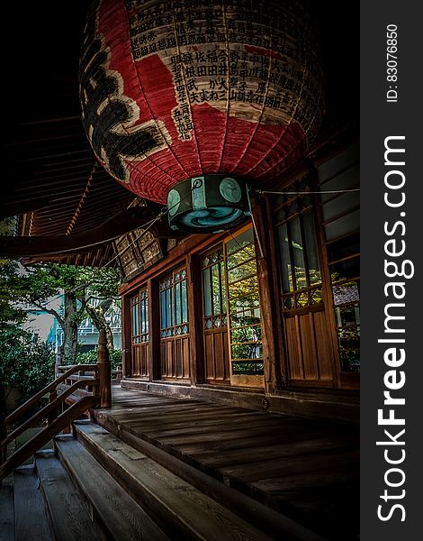 Red Green and Black Floating Lantern With Kanji Text Decoration Above Stairs