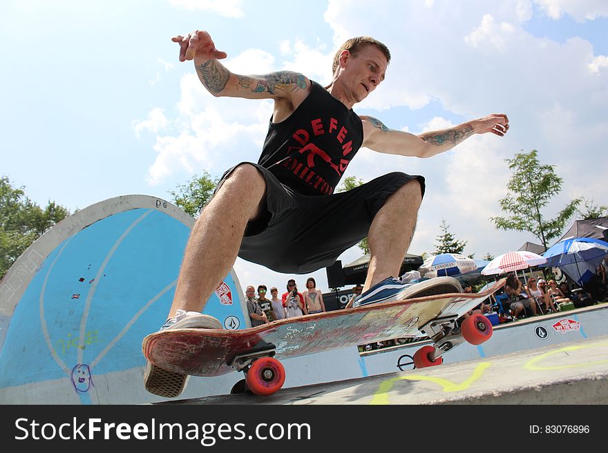 A man skateboards at a park outdoors. A man skateboards at a park outdoors.