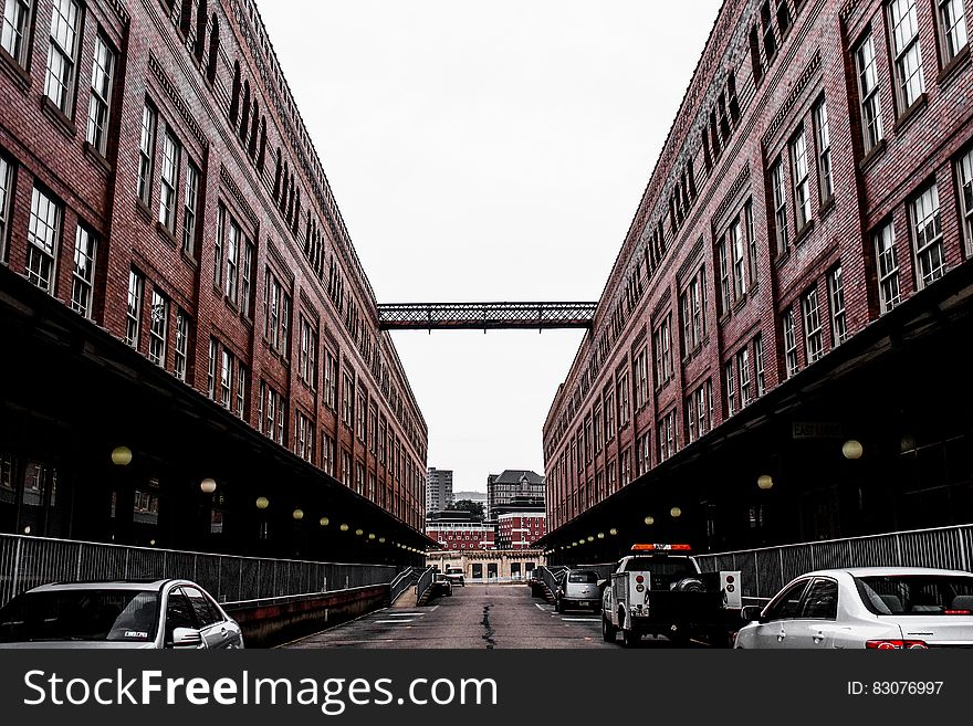 Red Painted Building With Cars Under It