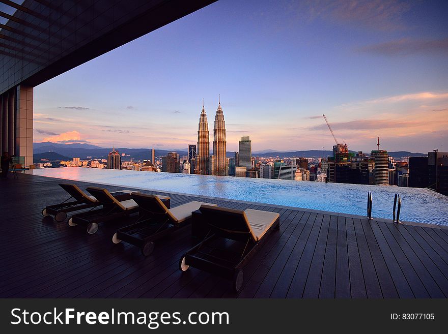 Brown Lounge Chair on Side of Swimming Pool