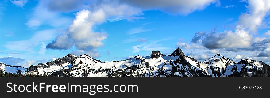 White And Black Snowy Mountain Under Blue Cloudy Sky