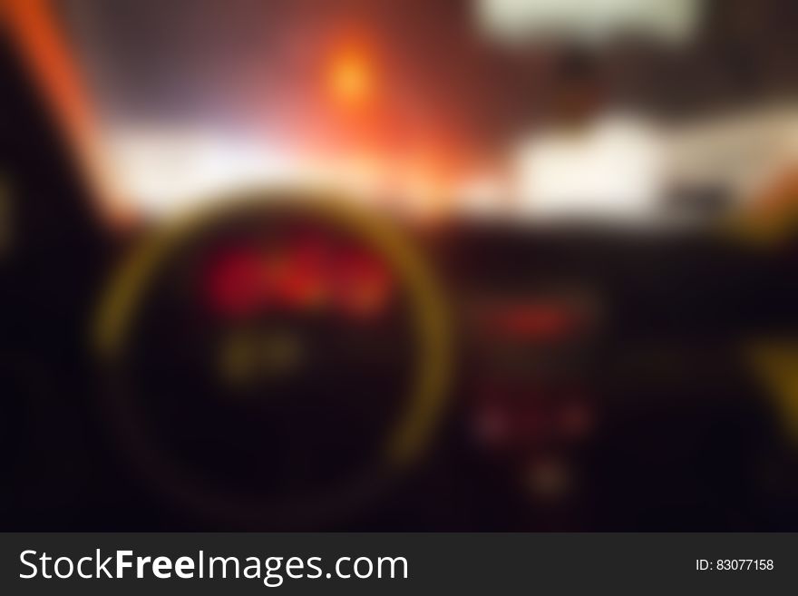 A blurred car interior at night.