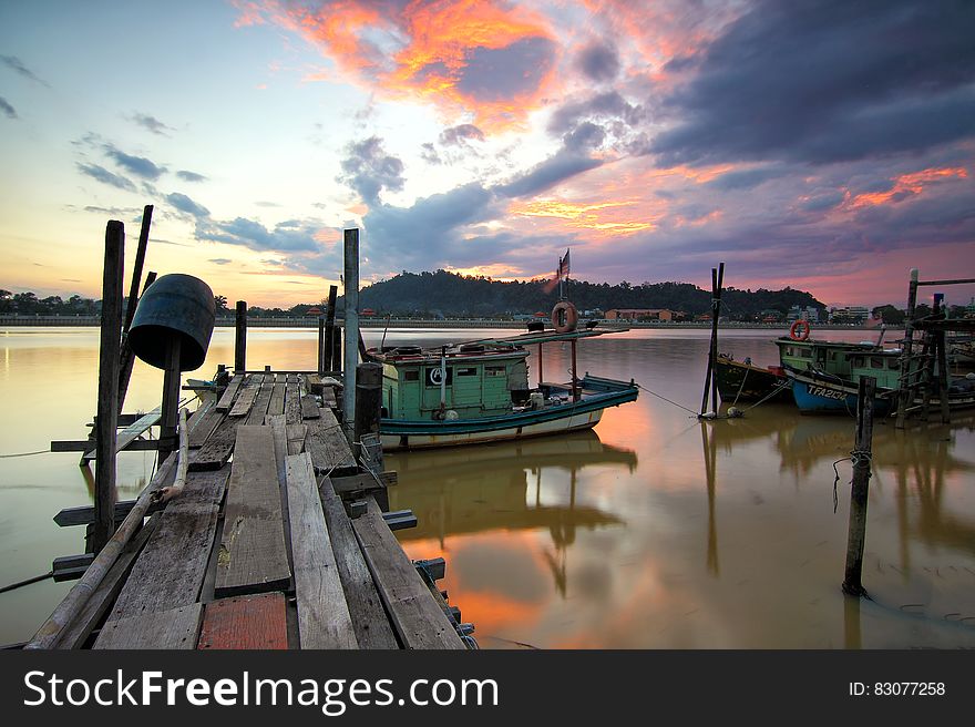 Jetty With Boats At Sunset