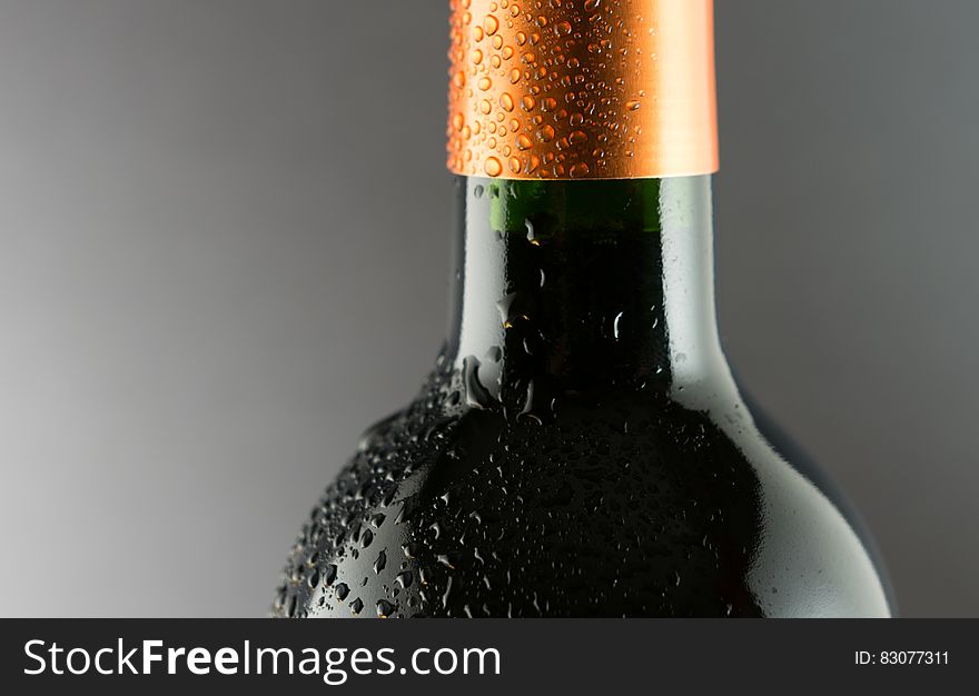 A close up of a wine bottle with condensed water on the surface. A close up of a wine bottle with condensed water on the surface.