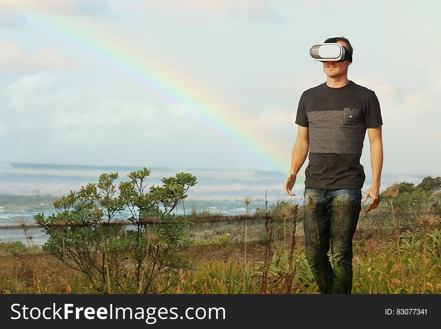 A man experiencing the outdoors with a virtual reality headset. A man experiencing the outdoors with a virtual reality headset.