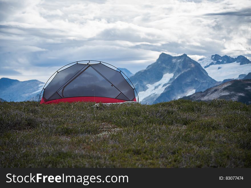 Scenic view of camping tent in snow capped mountainous landscape. Scenic view of camping tent in snow capped mountainous landscape.