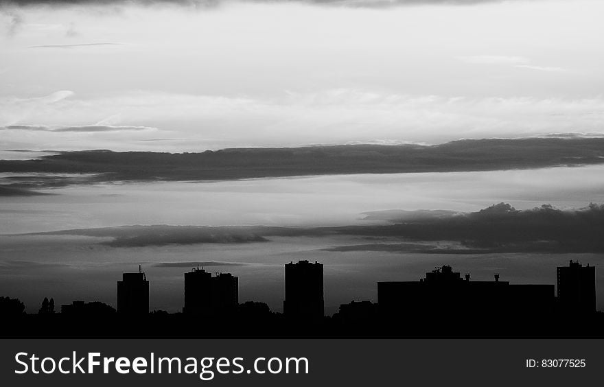Silhouette of Buildings Under Gray Clouds