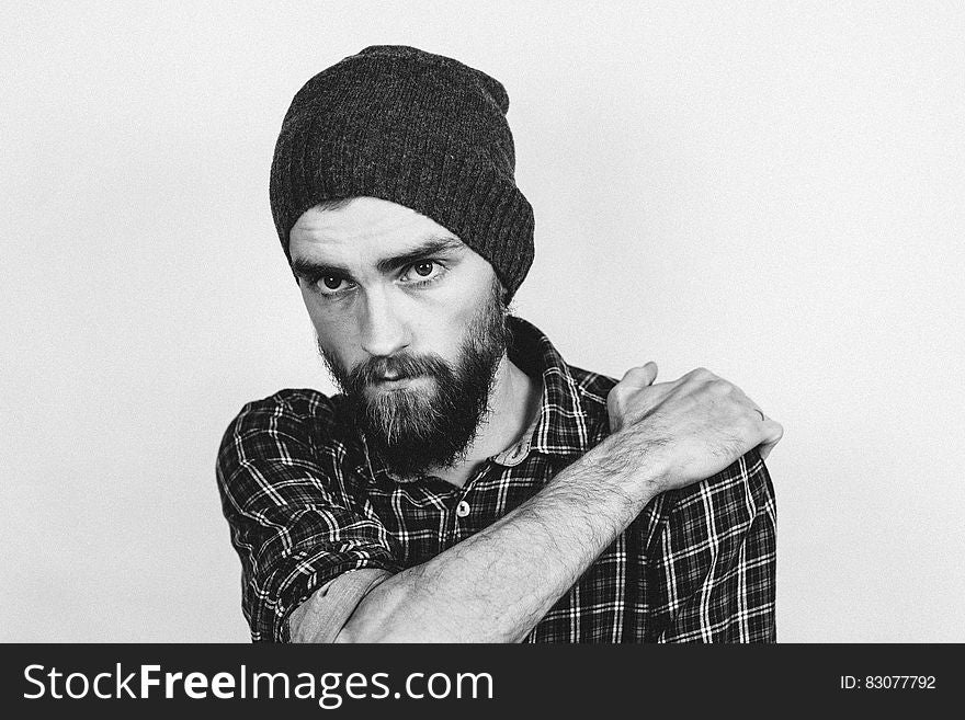 Man In Beanie Holding His Shoulder