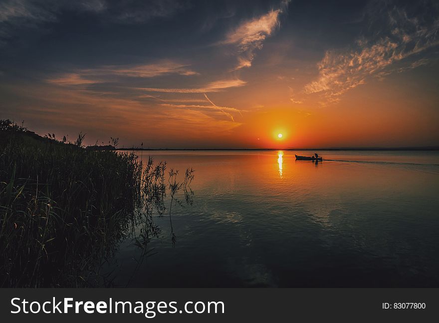 Person on a Boat Traveling during Sun Set