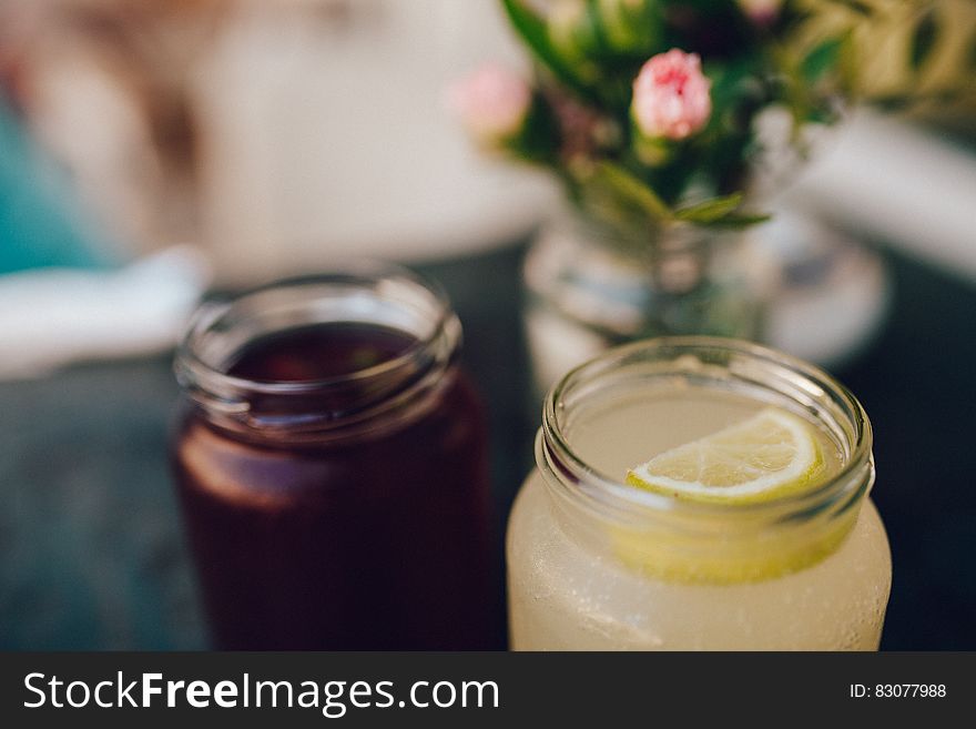 Clear Glass Mason Jar With Lemon Slice on Top of Cocktail