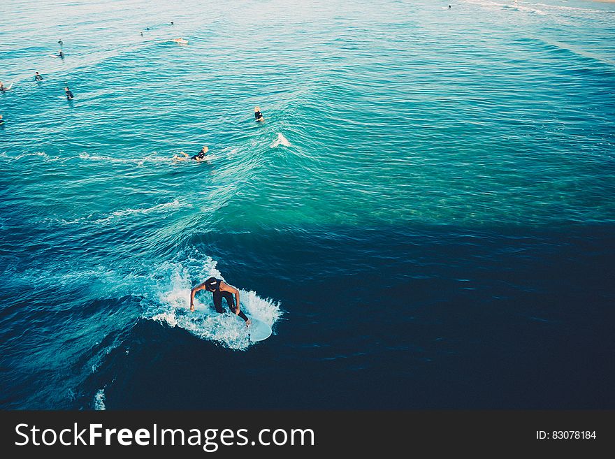 The ocean surface with swimmers and surfers on the waves. The ocean surface with swimmers and surfers on the waves.
