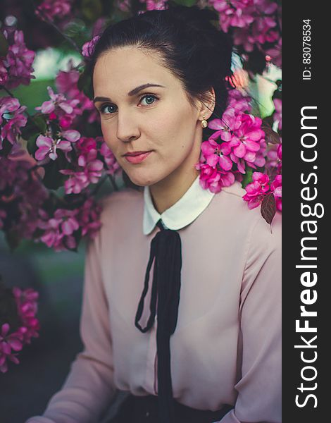 Woman Wearing Pink And White Collared Long Sleeve Dress Shirt Under Blooming Pink Petaled Flower