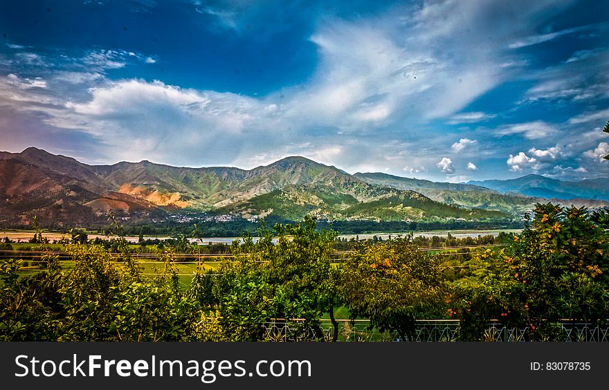 Nature Photography of Mountains and Trees Under Cloudy Sky during Daytime