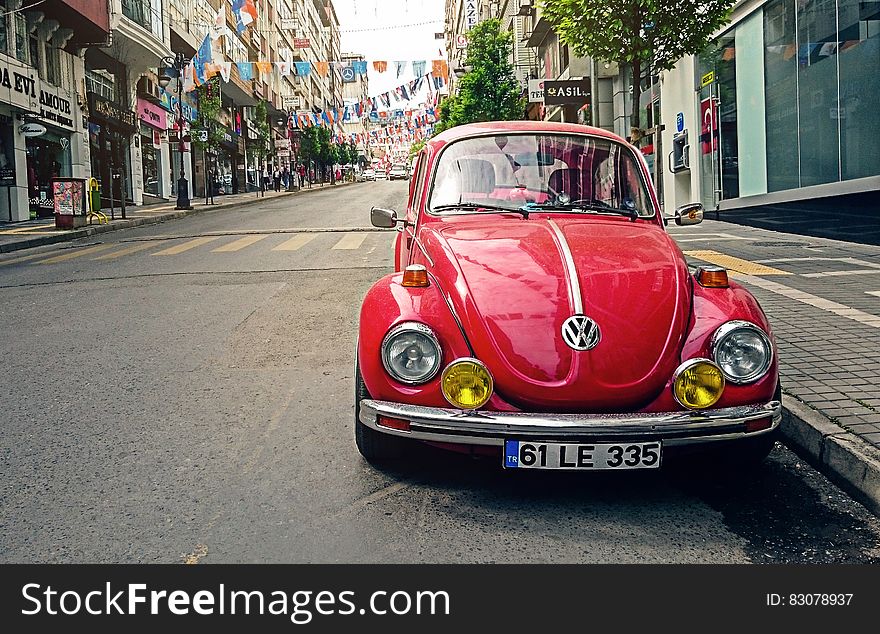 Red Volkswagen Beetle Parked at Road Side Near Pedestrian Lane