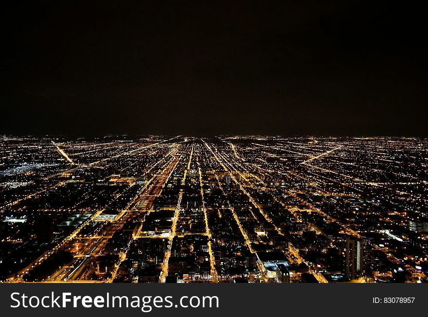 Birdseye view over illuminated city at night. Birdseye view over illuminated city at night