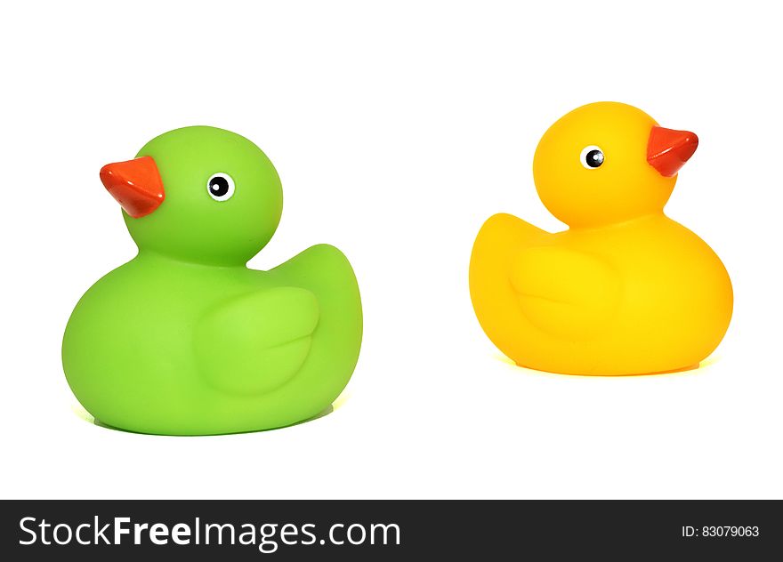 Yellow Duck Toy Beside Green Duck Toy