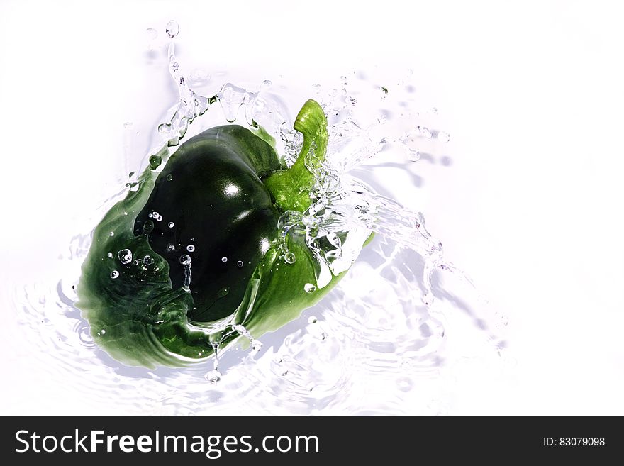 Fresh green bell pepper paprika splashing in Water. Fresh green bell pepper paprika splashing in Water
